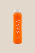 Bottle of Citrus Glow Juice, organic cold-pressed orange, pineapple, carrot and turmeric juice by SANA Wellness Bar, Orlando
